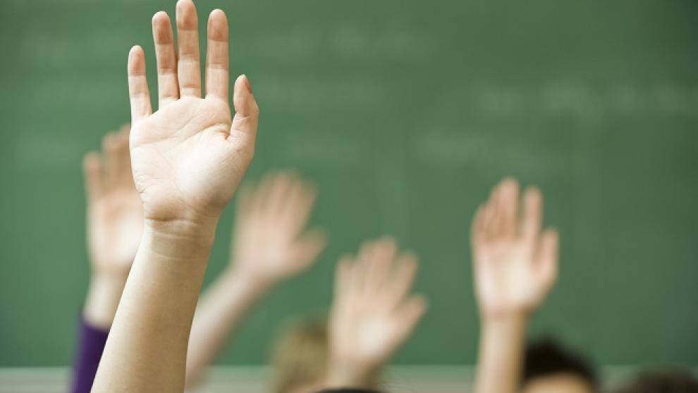 Raised hands in a classroom